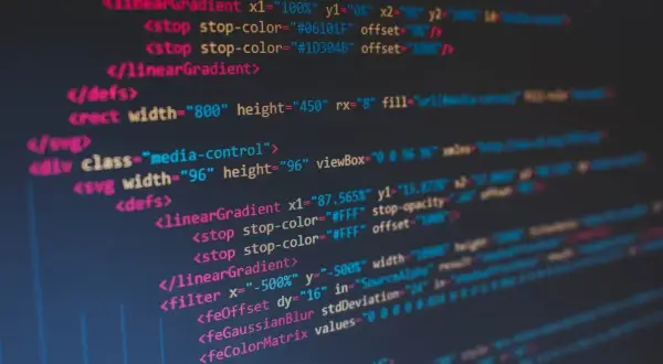Kod SVG z gradientami i filtrami. Widać tagi `<linearGradient>`, `<filter>`, `<feOffset>`, `<feGaussianBlur>`. To kod, który tworzy grafikę, dając jej spacja inaczej.