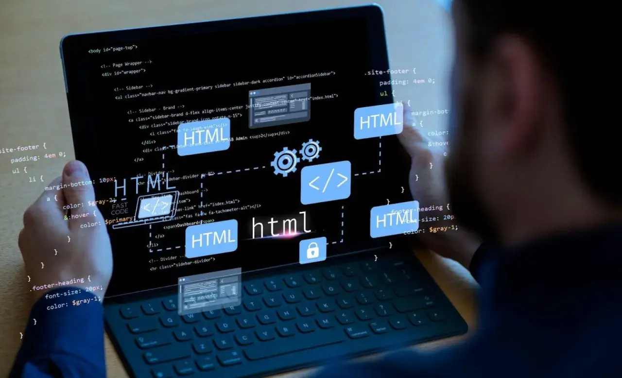 Programista pracuje nad stroną internetową, widoczny kod HTML i ikony symbolizujące tworzenie stron.