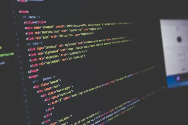 Kod HTML i CSS na ekranie, tworzący strukturę strony internetowej. Widoczne linki do plików stylów, w tym `theme.css`.